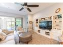 Living room with built-in shelving and TV at 21258 W Meadowbrook Ave, Buckeye, AZ 85396