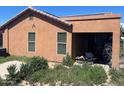 Rear view of the house with covered patio at 46157 W Holly Dr, Maricopa, AZ 85139