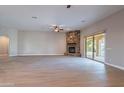 Living room features a stone fireplace and sliding glass doors at 3802 N 147Th Dr, Goodyear, AZ 85395