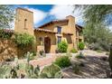 Spanish-style home with a welcoming front entrance and landscaping at 38749 N 104Th Way, Scottsdale, AZ 85262