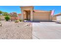 Tan stucco home with tile roof, double garage, and desert landscaping at 1247 E Marketplace Se Way, Phoenix, AZ 85048