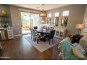 Bright dining room with an adjacent kitchen and access to the backyard patio at 41417 N Clear Crossing Rd, Anthem, AZ 85086