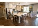 Modern kitchen featuring white cabinets, stainless steel appliances, and an island at 41417 N Clear Crossing Rd, Anthem, AZ 85086