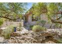 House exterior showcasing unique architectural details and natural rock landscaping at 9818 N 17Th St, Phoenix, AZ 85020