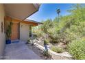 Home's front entrance with a walkway leading to the front door and a view of the backyard at 9818 N 17Th St, Phoenix, AZ 85020