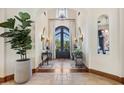 Elegant entryway with high ceilings and wrought iron doors at 9926 E Kemper Way, Scottsdale, AZ 85255