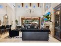 Luxury living room with large windows and fireplace at 9926 E Kemper Way, Scottsdale, AZ 85255