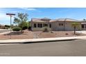 Front view of a single story house with well maintained landscaping at 15437 W La Salinas Ln, Surprise, AZ 85374