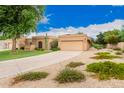 Front view of house with driveway and landscaping at 10511 N 104Th Pl, Scottsdale, AZ 85258