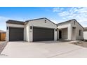 Two-car garage home with desert landscaping and a neutral color palette at 37535 W Padilla St, Maricopa, AZ 85138