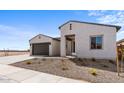 Two-car garage home with desert landscaping and a neutral color palette at 37535 W Padilla St, Maricopa, AZ 85138