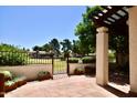 Private patio with wrought-iron gate and access to a grassy area at 11625 N 40Th Way, Phoenix, AZ 85028