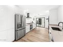 Modern kitchen with stainless steel appliances and light wood floors at 7113 E Mcdonald Dr, Paradise Valley, AZ 85253