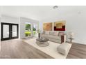 Bright living room featuring light beige sofa and large windows at 7113 E Mcdonald Dr, Paradise Valley, AZ 85253