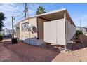 Side view of mobile home with privacy fence at 2121 N Center St # 197, Mesa, AZ 85201