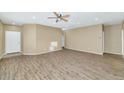 Spacious living room featuring wood-look floors and ceiling fan at 30200 N Desert Willow Blvd, San Tan Valley, AZ 85143