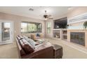 Living room featuring a fireplace, large TV, and comfortable seating at 11500 E Cochise Dr # 2011, Scottsdale, AZ 85259