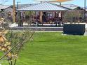 Community playground with covered pavilion and play structures at 16214 W Questa Dr, Surprise, AZ 85387