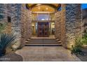 Stunning stone exterior with a grand entrance and arched entryway at 9673 E Oberlin Way # 15, Scottsdale, AZ 85262
