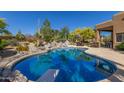 Inviting kidney-shaped pool with diving board at 6964 E Redbird Rd, Scottsdale, AZ 85266