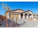 Two-story house exterior with a driveway and landscaping at 21970 E Stirrup E Ct, Queen Creek, AZ 85142