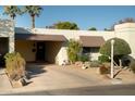 Single-story home with a carport and mature desert landscaping in front at 5410 N 78Th Pl, Scottsdale, AZ 85250