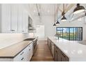 Modern kitchen with white cabinets, stainless steel appliances, and large island at 8509 S 10Th Ln # 23, Phoenix, AZ 85041