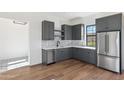 Stylish bar area with dark gray cabinets and stainless steel appliances at 8509 S 10Th Ln # 23, Phoenix, AZ 85041