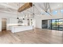 Modern kitchen with white cabinets, large island, and exposed beams at 8509 S 10Th Ln # 23, Phoenix, AZ 85041