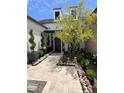 Elegant front entry with landscaped walkway and modern lighting at 5755 S Joshua Tree Ln, Gilbert, AZ 85298