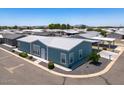 Aerial view of a light blue manufactured home with a carport and surrounding community at 1051 E Four St, San Tan Valley, AZ 85140