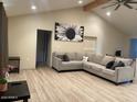 Spacious living room with L-shaped sectional sofa and wood-look flooring at 2303 W Marshall Ave, Phoenix, AZ 85015