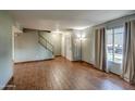 Living room showcasing hardwood floors and a view of the backyard at 4443 W Solano S Dr, Glendale, AZ 85301