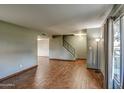 Living room with hardwood floors, staircase, and large windows at 4443 W Solano S Dr, Glendale, AZ 85301