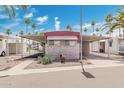 Mobile home with covered carport and desert landscaping at 305 S Val Vista Dr # 202, Mesa, AZ 85204