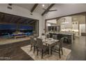 Open concept dining room with a large table and access to the kitchen and backyard at 21106 W Granite Ridge Rd, Buckeye, AZ 85396