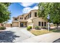 Two-story house with landscaping and driveway, offering curb appeal at 16612 N 151St Ln, Surprise, AZ 85374