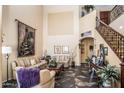 Spacious living room with high ceilings, a staircase and tiled floors at 16612 N 151St Ln, Surprise, AZ 85374