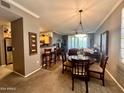 Bright dining area with a table and chairs, open to the living room at 20100 N 78Th Pl # 3090, Scottsdale, AZ 85255