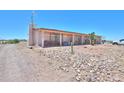 Ranch style house with a gravel yard, partially visible vehicle, and a mountainous background at 3510 S Verbena Rd, Casa Grande, AZ 85193