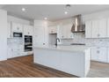 Spacious kitchen with white cabinets, large island, and stainless steel appliances at 10010 S 37Th Ave, Laveen, AZ 85339