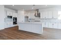 Spacious kitchen with white cabinets, large island, and stainless steel appliances at 10010 S 37Th Ave, Laveen, AZ 85339