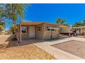 Tan single-wide mobile home with carport and small front yard at 8125 E Billings St, Mesa, AZ 85207