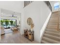 Bright and airy entryway with light wood floors and staircase at 4007 E Montecito Ave, Phoenix, AZ 85018