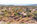 Aerial view showing a single-story house with a pool, in a desert setting at 30619 N 63Rd St, Cave Creek, AZ 85331