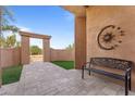 Peaceful courtyard with wrought iron bench and sun/moon art at 26812 N 161St St, Scottsdale, AZ 85262