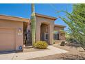 Front entry and walkway with a large saguaro cactus at 9768 E Balancing Rock Rd, Scottsdale, AZ 85262