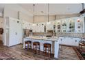 Modern kitchen with white cabinets, granite counters, and large island at 9768 E Balancing Rock Rd, Scottsdale, AZ 85262