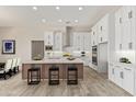 Spacious kitchen with white cabinets, an island, and modern appliances at 1973 W Brooke Ln, Queen Creek, AZ 85144
