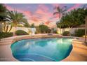 Inviting swimming pool with waterfall feature and lights at 2055 S Marble St, Gilbert, AZ 85295